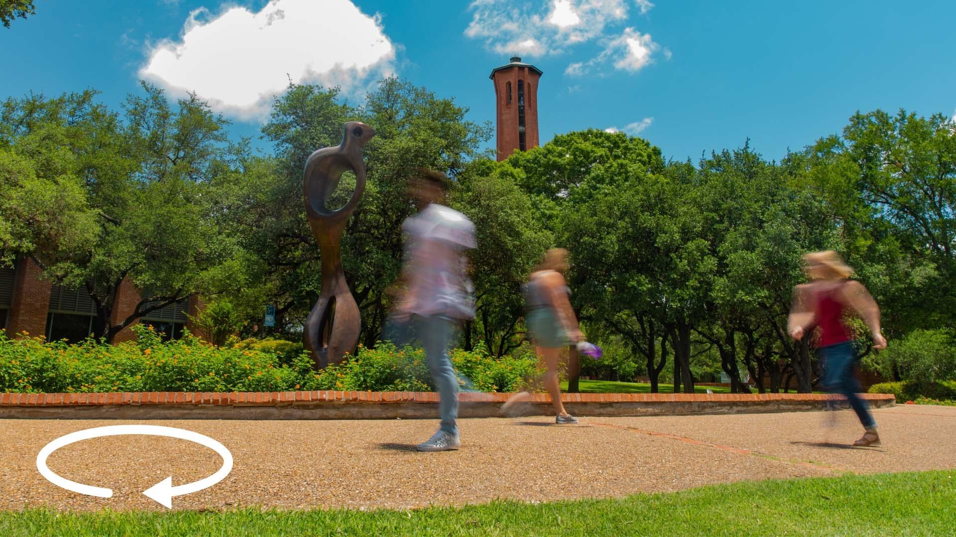 photo of students walking on a sidewalk