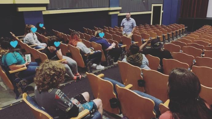 Students and staff gathered in an auditorium