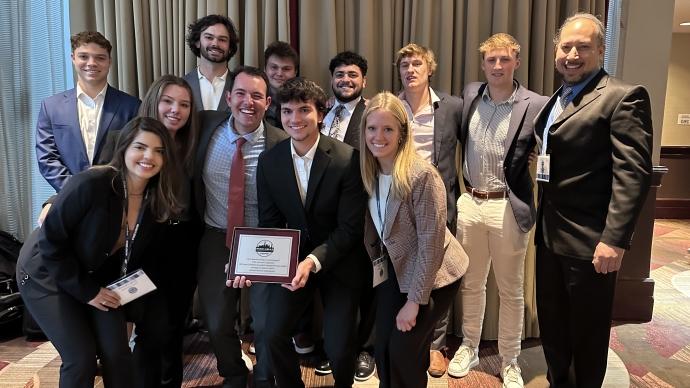 The members of the Student Managed Fund Class of 2024 pose for a photo with their certificate and their faculty mentor