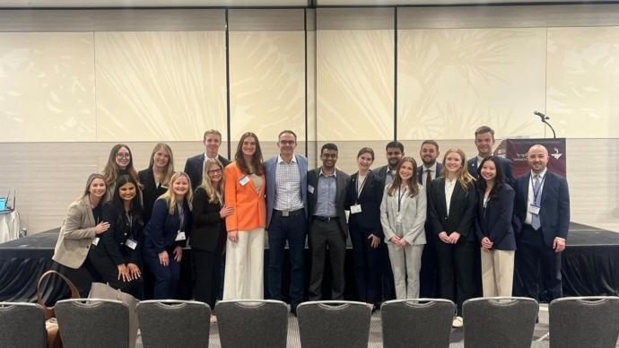 HCAD students pose for a photo with Trinity professor Amer Kaissi in a conference room