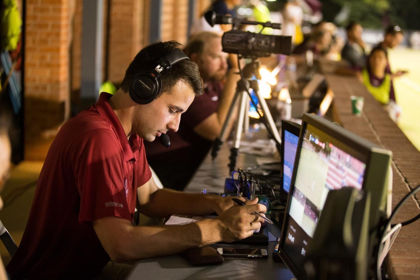 A student helps broadcast a soccer match