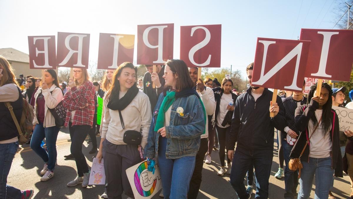 Group of students demonstrating with inspire sign