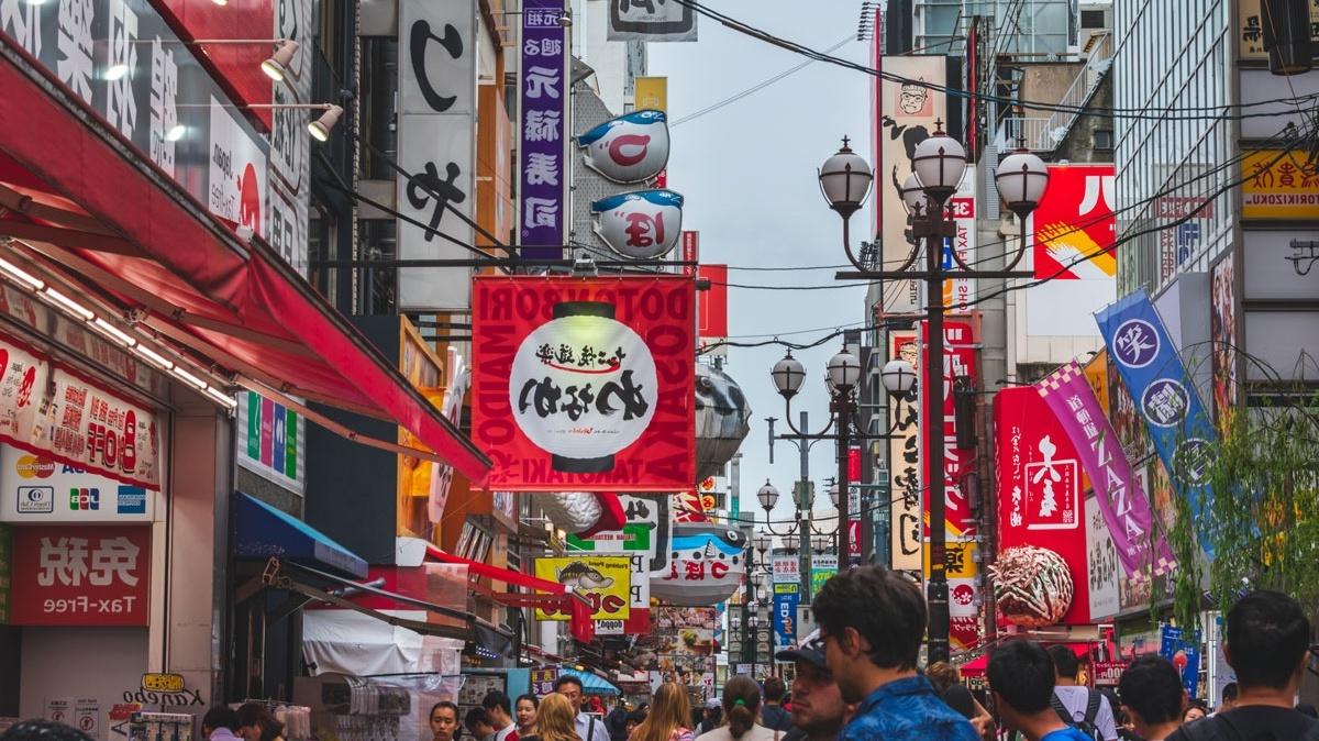 A street in a chinese city is covered in promotional signage